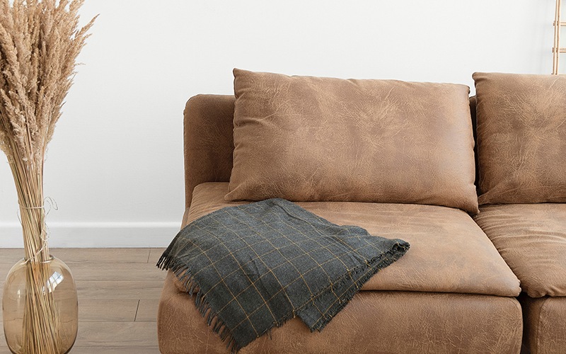 lifestyle image of a brown couch with modern decor nearby
